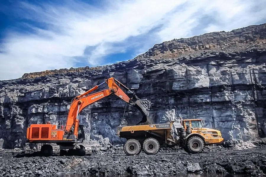 Excavator loading a dumper in a quarry